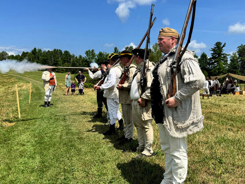 Reenactors participate in a loading and reloading competition to demonstrate the difficulties of fighting with the guns of the day.
