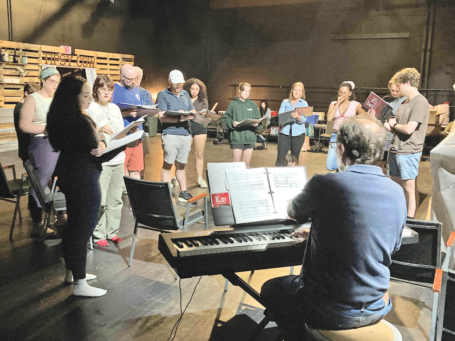 Photo by Mary Recchia. Carl Recchia leads a music rehearsal for “KIN” at the Main Street Landing Blackbox theatre.