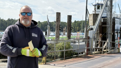 Photo by Steve Goldstein. Aaron Flinn went from full-time musician to working on the ferry and part-time musician when mounting medical bills required a career change.