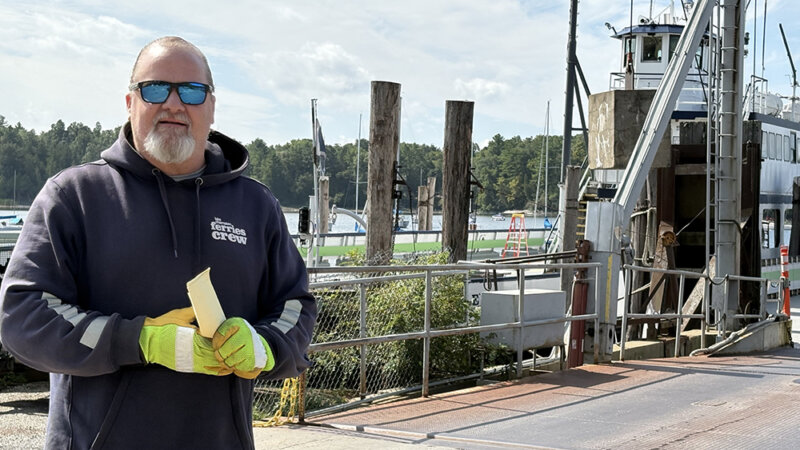 Photo by Steve Goldstein. Aaron Flinn went from full-time musician to working on the ferry and part-time musician when mounting medical bills required a career change.