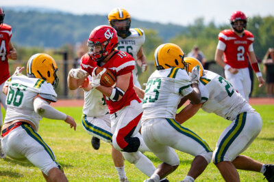 Photos by Calvin Morse. No. 10 John Saladino battles through Bobwhite defenders in one of several punishing runs he had up the middle against BFA-St. Albans in a 31-3 win for Champlain Valley on Sept. 13.