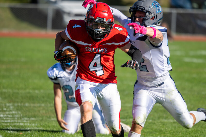 Photo by Calvin Morse. The Redhawks’ Connor Nichols sheds Seawolves’ would-be tacklers.